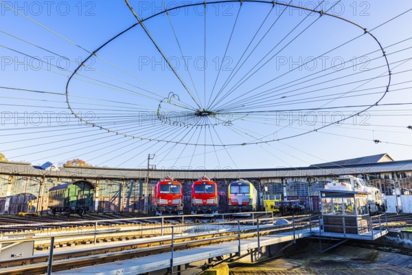Turntable and overhead line spider, behind it modern locomotives of the Austrian Federal Railways, ÖBB, and Deutsche Bahn, DB, parked in front of the old lock shed, Augsburg railway park, administrative district of Swabia, Bavaria, Germany