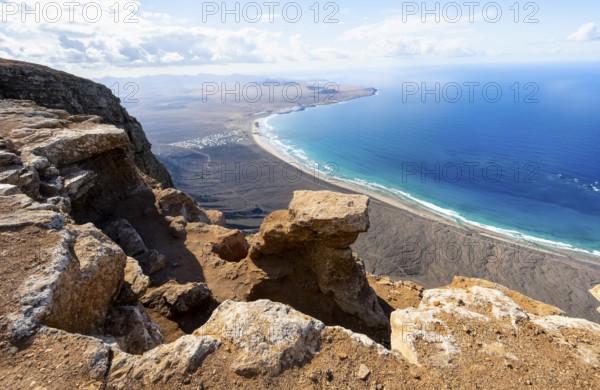 View from the Risco de Famara Cliff to Famara Beach, Playa de Famara with La Calaeta, Lanzarote, Canary Islands, Spain