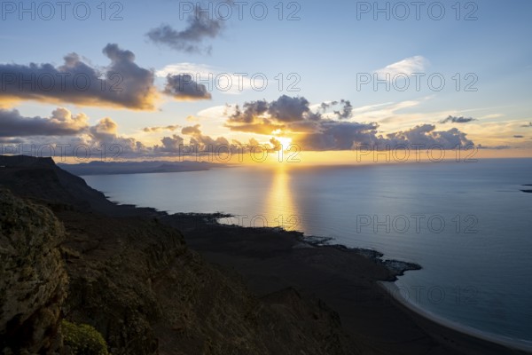 View of steep cliffs on sea and coast, Mirador del Porrito viewpoint at sunset, Lanzarote, Canary Islands, Spain