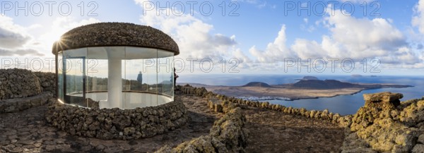 Stairway and viewing platform at the Mirador del Río viewpoint, in the evening light with sun stars, designed by artist César Manrique, view of the island of La Graciosa, Lanzarote, Canary Islands, Spain