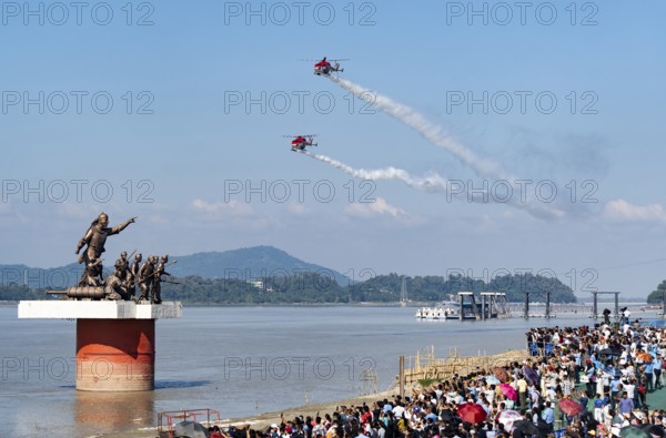 Indian Air Force (IAF) ALH Mk1 Sarang helicopters soar through the sky during an air show as part of the 93rd Air Force Day celebrations on November 8, 2025 in Guwahati, India