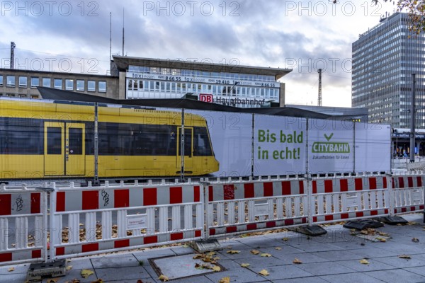 Construction site of the stop at the main train station, for the new city railway, visualization of the full-size tram, a new tram line over 5 km long, which will connect the west of Essen, the new district 51, with the city center, from 2026, Essen, North Rhine-Westphalia, Germany