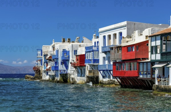 Mykonos, Cyclades, Greece - Little Venice is a picturesque neighborhood in Mykonos Town with colorful houses that stand right by the sea and are reminiscent of Venice. Little Venice is located on Alefkandra Bay next to the famous windmills of Mykonos. Mykonos is part of the Cyclades archipelago in the Aegean Sea