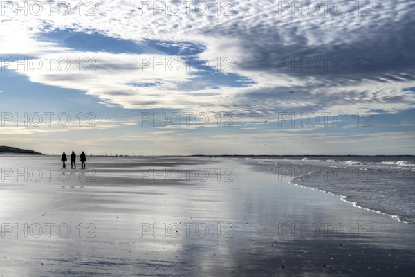 Walkers on the Wadden Sea near the East Frisian island of Spiekeroog, west of the North Sea island, at low tide, Lower Saxony, Germany