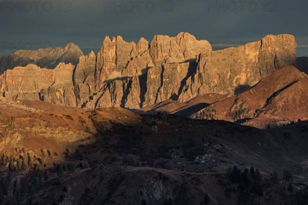 Steep mountains, mountain range, sunset, cloudy, autumn, Pordoi Pass, view of Croda da Lago, Dolomites, Italy