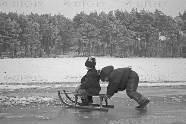 Children ride sledges on ice rink, Bleckede, Lower Saxony, Germany, January 04, 1995, vintage, retro, old, historic