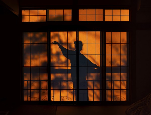 Shadows of a woman in kimono, on the balcony behind sliding shoji doors in a traditional Japanese house, ninja, Yamanouchi, Nagano, Japan