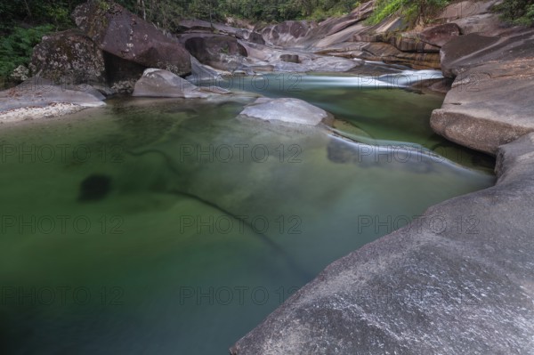 Turquoise blue water between rocks in the tropical rainforest of Babinda Boulders Queensland Australia