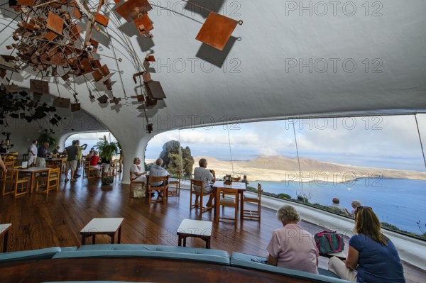 Interior of café with panoramic window in building designed by Cesar Manrique with the collaboration of Jesús Soto and architect Eduardo Caceres without right angles corners on viewpoint tourist attraction El Mirador del Río on the summit of the 474 meter high Risco de Famara in Famaramassiv with panoramic view of the Chinijo Archipelago, La Graciosa island, Lanzarote, Canary Islands, Canary Islands, Spain