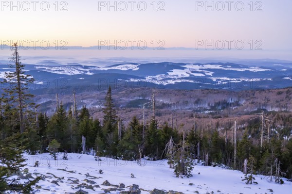 View from Mount Lusen over the hills of the bavarian forest at sunrise in winter, Bavaria, Germany