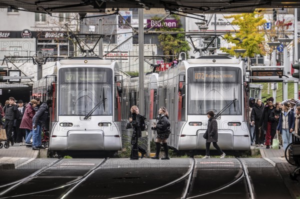Pedestrians cross the tram tracks, at Düsseldorf-Bilk station, junction of S-Bahn, subway, tram, local bus transport, North Rhine-Westphalia