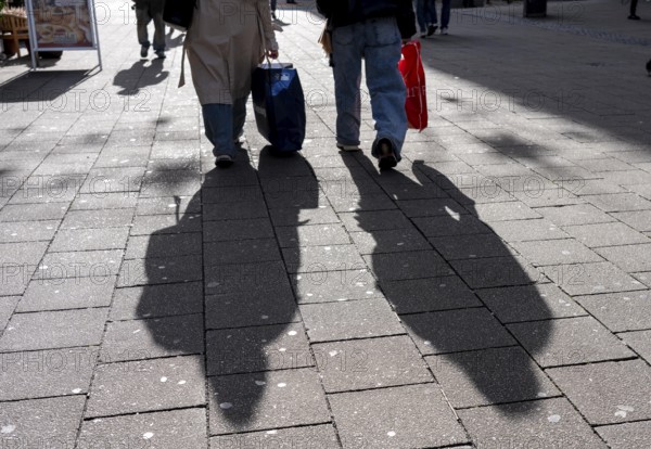 Shadows of passers-by shopping in the city center, Essen, North Rhine-Westphalia