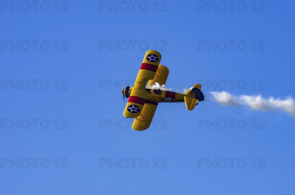 A Boeing PT-17 Stearman biplane, also Boeing Stearman Model 75, with the inscription 399 USNAVY N67193 during a flight demonstration as part of an air show on Rossfeld in Metzingen-Glems, Baden-Württemberg, Germany, for editorial use only