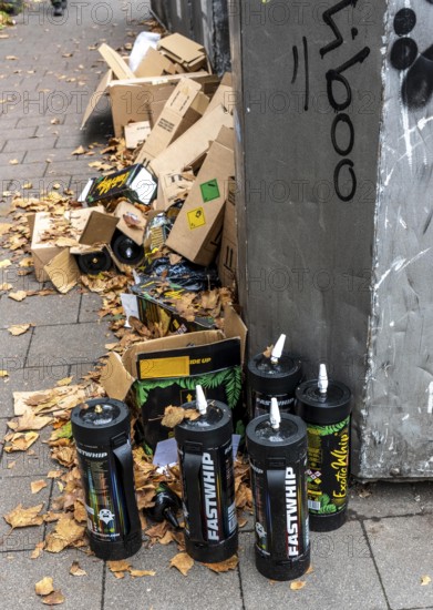 Empty cartridges filled with N2O, nitrous oxide gas, called laughing gas, officially it serves as a propellant to produce whipped cream in appropriate devices, but is often used as an intoxicant, party drug, misused, here mass, illegal disposal in addition to waste paper containers in Düsseldorf, North Rhine-Westphalia, Germany