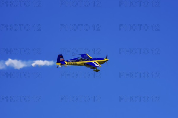 An Extra EA-300 from Extra Flugzeugproduktions- und Vertriebs GmbH with registration D-EXBH during a flight demonstration as part of an air show on Rossfeld in Metzingen-Glems, Baden-Württemberg, Germany, for editorial use only