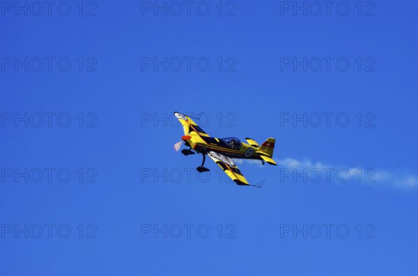 A Votec 351 sport aircraft from the Swiss MSW Aviation AG with registration HB-YMV during a flight demonstration as part of an air show on Rossfeld in Metzingen-Glems, Baden-Württemberg, Germany, for editorial use only
