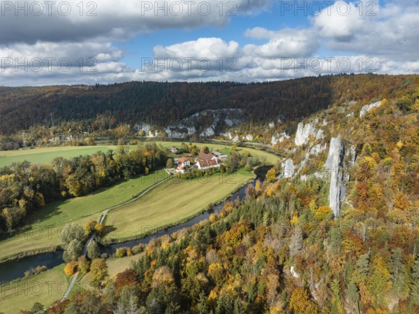 Aerial view of Käppeler Manor with St. George's Basilica near Thiergarten in the Upper Danube Valley, surrounded by autumn vegetation, on the right the raven rocks, climbing rocks, Jura limestone rocks, Sigmaringen district, Baden-Württemberg, Germany
