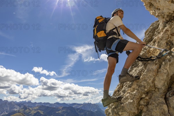 Mountaineer climbs on Ferrata Furcela de Saslonch, Langkofelscharte via ferrata, Dolomites, Trentino, South Tyrol, Italy