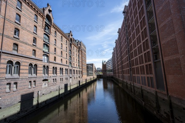 Canal between red brick buildings, warehouses in Hamburg's Speicherstadt, Hamburg, Germany
