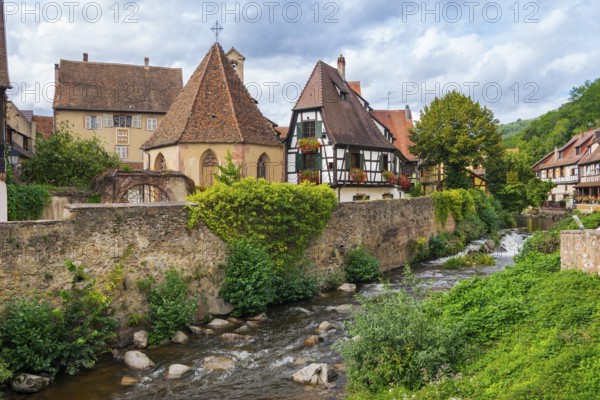 Picturesque Kaysersberg with half-timbered houses on the Weiss river in the old town centre