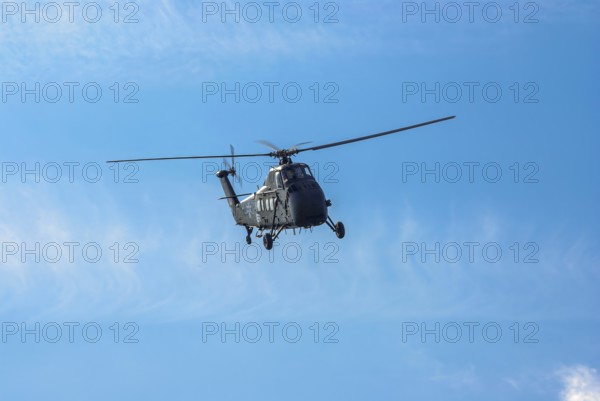 A Sikorsky S-58C transport helicopter in the colours of the German Army with the registration D-HAUG during a flight demonstration as part of an air show at the Rossfeld in Metzingen-Glems, Baden-Württemberg, Germany, for editorial use only