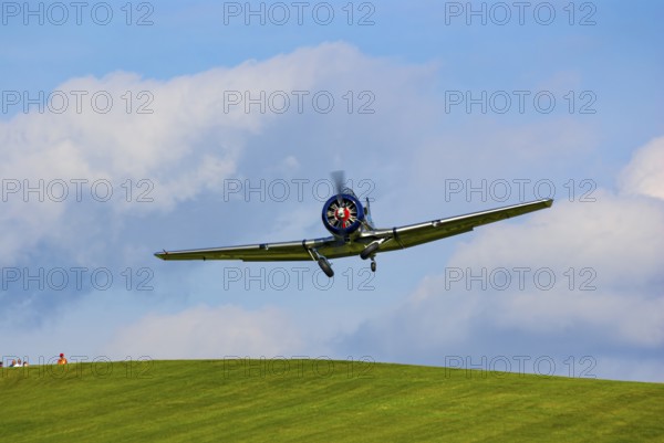 A North American AT-6D with the registration D-FAML during a flight demonstration as part of an air show at the Rossfeld in Metzingen-Glems, Baden-Württemberg, Germany, for editorial use only