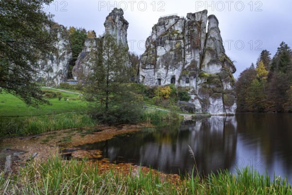 Externsteine in autumn, view over the Wiembecke pond, Teutoburg Forest, Horn-Bad Meinberg, North Rhine-Westphalia, Germany