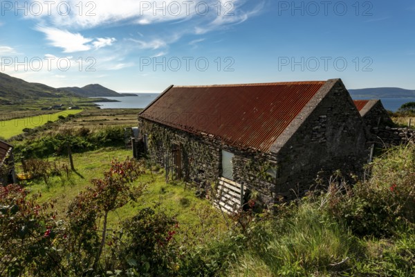 Stone farm buildings with rusty corrugated iron roof, Ring of Kerry, Iveragh Peninsula, County Kerry, Ireland