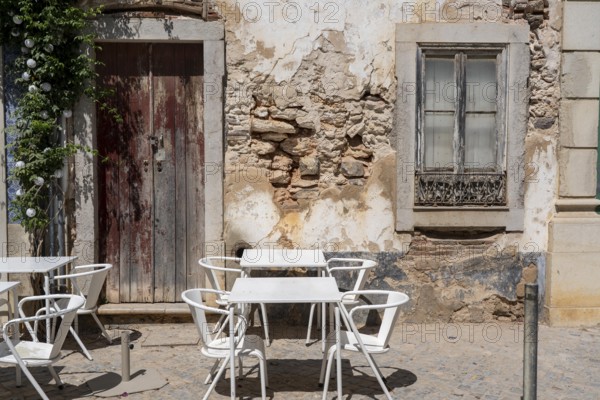 Restaurant furniture, for outdoor catering, tables, chairs, stacked, day off, catering closed, old town of Tavira, Algarve, Portugal