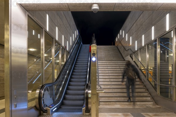 Night photo, long exposure with motion blur, modern underground entrance at Unter den Linden station, contemporary design with stairs and escalator, Berlin, Germany