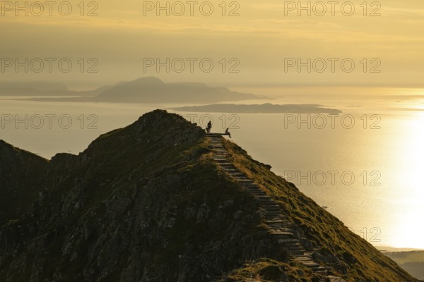 Hikers on the Rørsethornet stone staircase, with 3292 steps one of the longest continuous stone staircases in the world, Sherpatreppe or Midsundtreppe or Midsundtrappene, Rørsethornet hike, evening mood, Otroya or Otrøya island, Møre og Romsdal, Norway