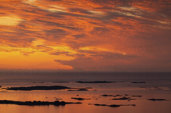 Offshore islands and skerries, sea, dramatically illuminated clouds, sunset, Otroya or Otrøya island, Møre og Romsdal, Norway