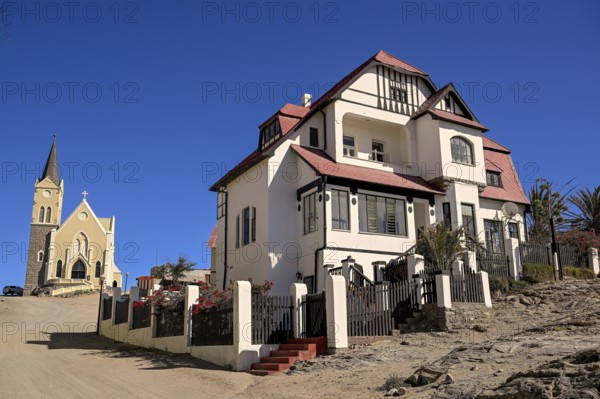 Colonial house facade in the Kirchstraße, in the background the rock church, Lüderitz, Karas region, Namibia