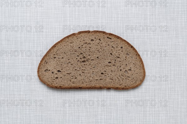 Top shot of a slice of bread on a white Resopal plate