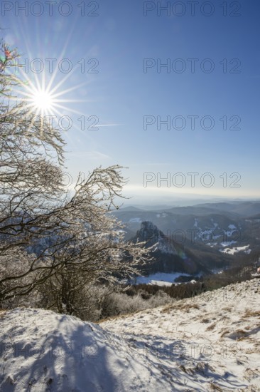 View over the hills and valleys from the mountain with hoarfrost on the branches in winter, Vápec, Horná Poruba, Slovakia
