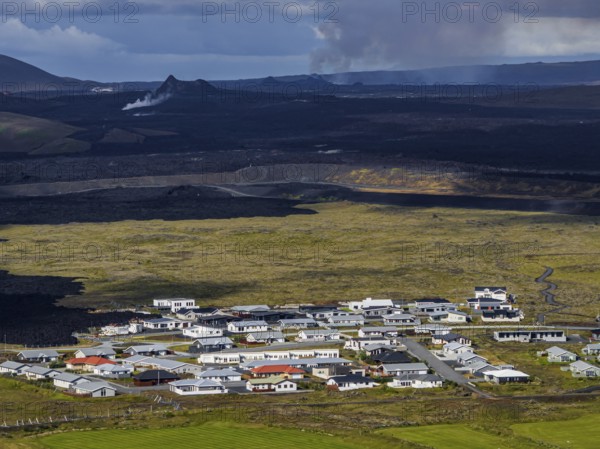 Lava, lava field, village, houses, summer, cloudy, sunny, aerial view, volcanic eruption, July 2025, Grindavik, Sundhnúkur crater series, Fagradalsfjall, Reykjanes, Iceland