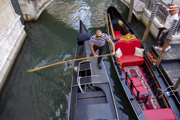 Venice, Italy - 3 September 2025: Gondolier on a gondola in Venice during the 82nd Venice International Film Festival