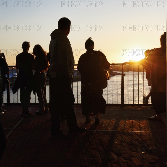 Crowd enjoying the view from the Elbphilharmonie over the Elbe at sunset, silhouettes, Plaza viewing platform, Hamburg, Germany