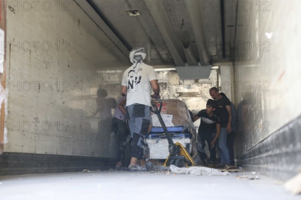 Relief workers unload boxes of medical aid provided by Qatar at Damascus International Airport, part of the humanitarian bridge supporting Syria's recovery and reconstruction after the fall of Bashar al-Assad, Damascus, Damascus, Syria