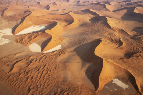 Sand dunes and dry pans in the Namib Desert. In the evening. Aerial view. Namib-Naukluft Park, Namibia