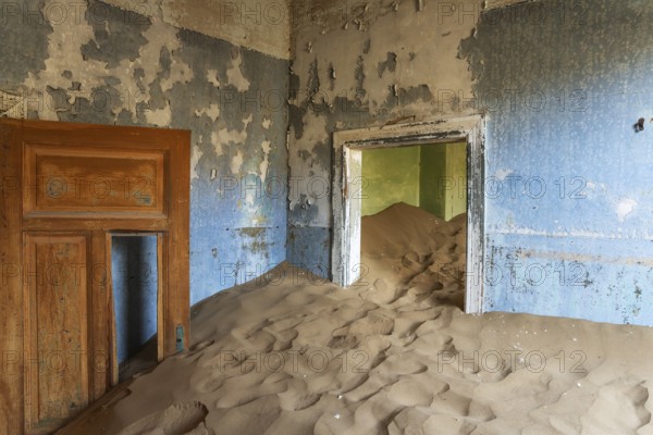 At Kolmanskop, the abandoned ghost town of the diamond days of the early 1900 and of German origin. Inside the restricted Diamond Area east of the coastal town of Lüderitz. Namib Desert, Namibia