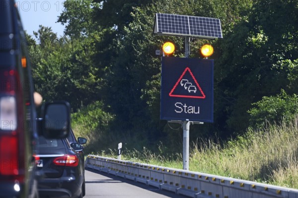 Traffic sign with solar-powered traffic jam warning on the motorway, Baden-Württemberg, Germany