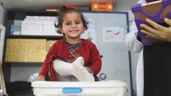 A doctor examining a refugee child for malnutrition in the camp using weight and height measurement. Aleppo, Syria October 18, 2022, Aleppo, Syria