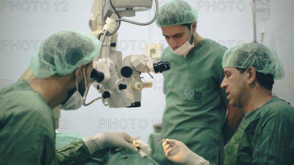 Several doctors performing a complex surgical operation inside an operating room for a displaced patient. Aleppo, Syria. October 18, 2022, Aleppo, Syria