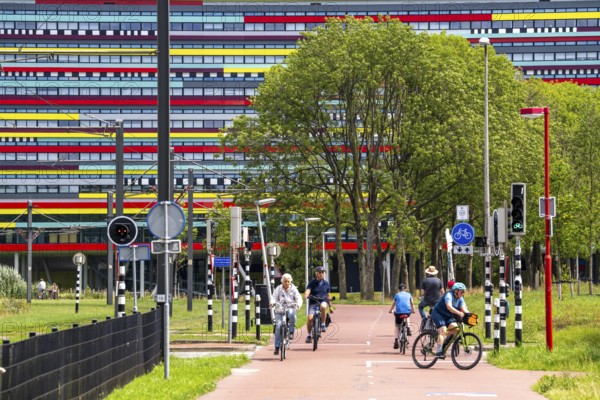 Cycle path through the university campus in Utrecht Science Park, Utrecht University, colourful facade of the Hogeschool Utrecht building, Netherlands