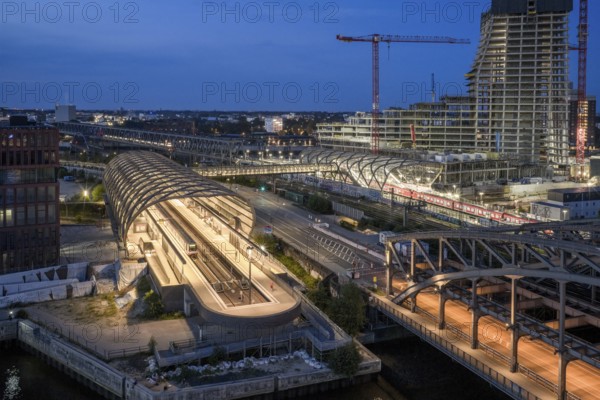 Blue hour aerial view of the Hamburg Elbbrücken U4 underground and suburban railway station and the Elbtower construction site, Hamburg, Germany
