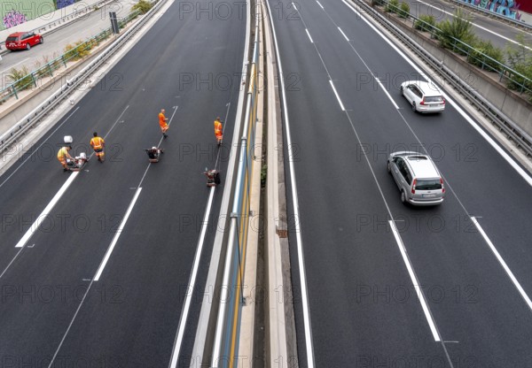 Rehabilitation of the A52 motorway near Essen, an 8 km long section between the Essen-Kettwig junction and the Essen-Ost motorway junction was completely rehabilitated over a period of 9 years, 6 lanes, new drainage pipes, carriageway, bridges, noise barriers, traffic facilities, here the last section, in the direction of Düsseldorf, new carriageway surface, laying of porous asphalt, whispering asphalt, marking work on the new carriageway, at the Essen-Rüttenscheid junction, North Rhine-Westphalia, Germany
