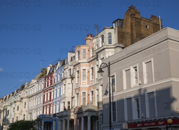 Terraced houses, townhouses with different, colourfully painted facades under a blue sky, Portobello Road, Notting Hill, London, England, Great Britain