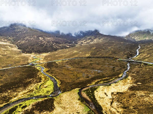 Eas a' Bhradain Waterfall from drone, Red Cuillin mountains, Loch Ainort, Isle of Skye, Scotland, UK
