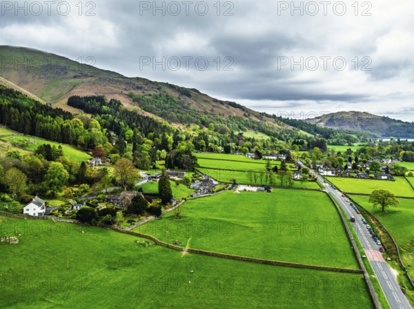 Farms and Mountains over road A591 from a drone, Grasmere Lake, Grasmere, Ambleside, Lake District, Westmorland, Cumbria, UK